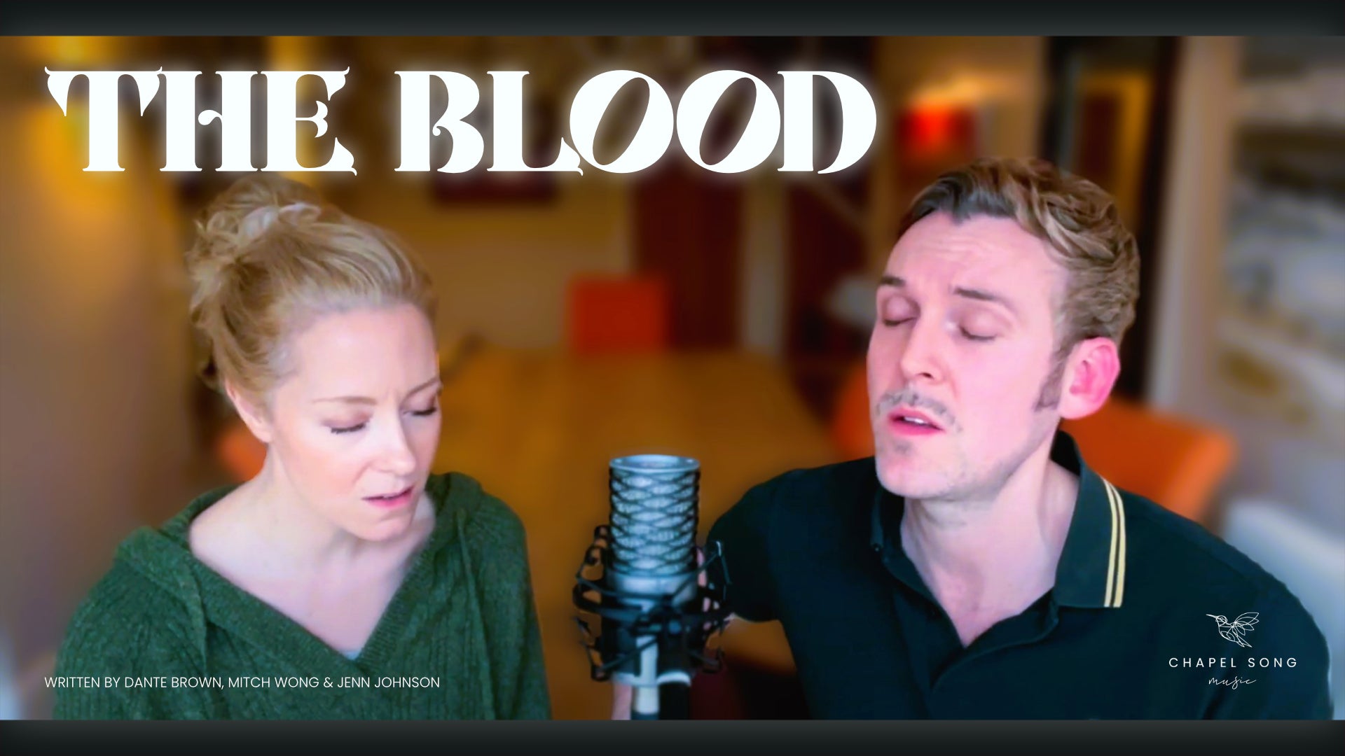 Load video: Rory and Sarah sitting together on stools with Rory playing guitar singing a song called The Blood